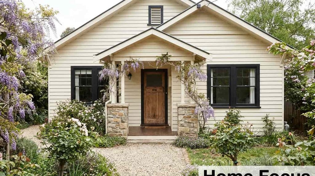 small cottage black windows cream siding 1024x572